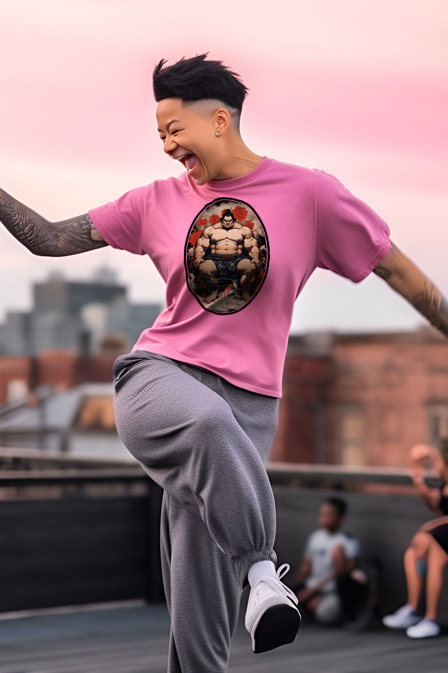 young tattooed woman wearing an Azalea-pink graphic t-shirt featuring a Sumo fighter print