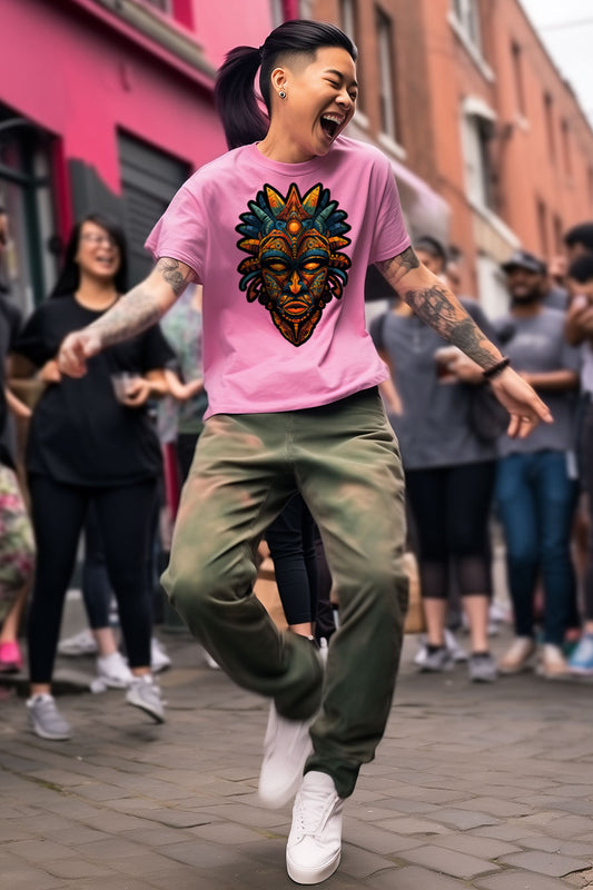 young tattooed woman wearing a Azalea-pink graphic t-shirt featuring a Aztec mask print