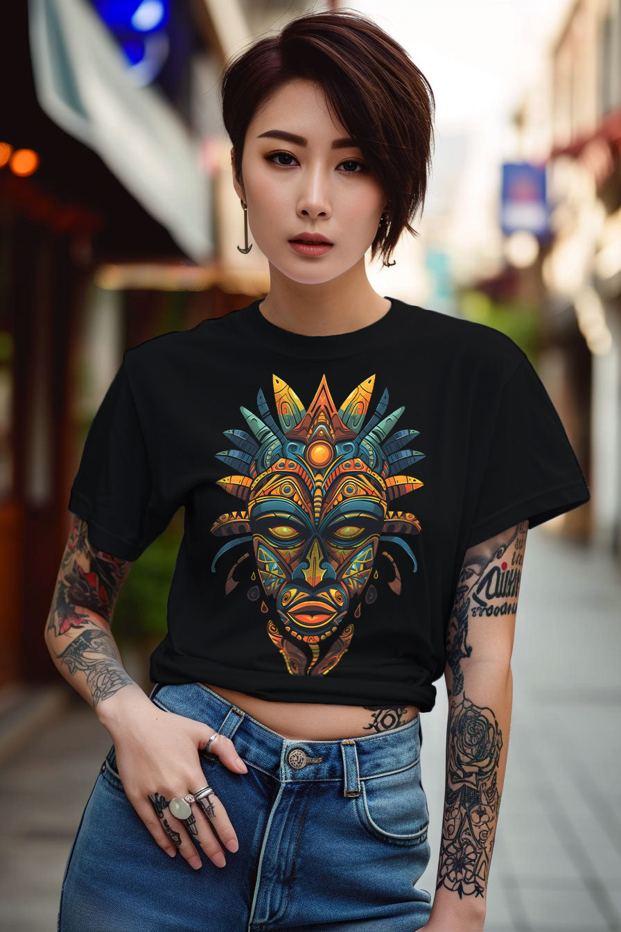 young tattooed woman wearing a black graphic t-shirt featuring a Aztec mask print