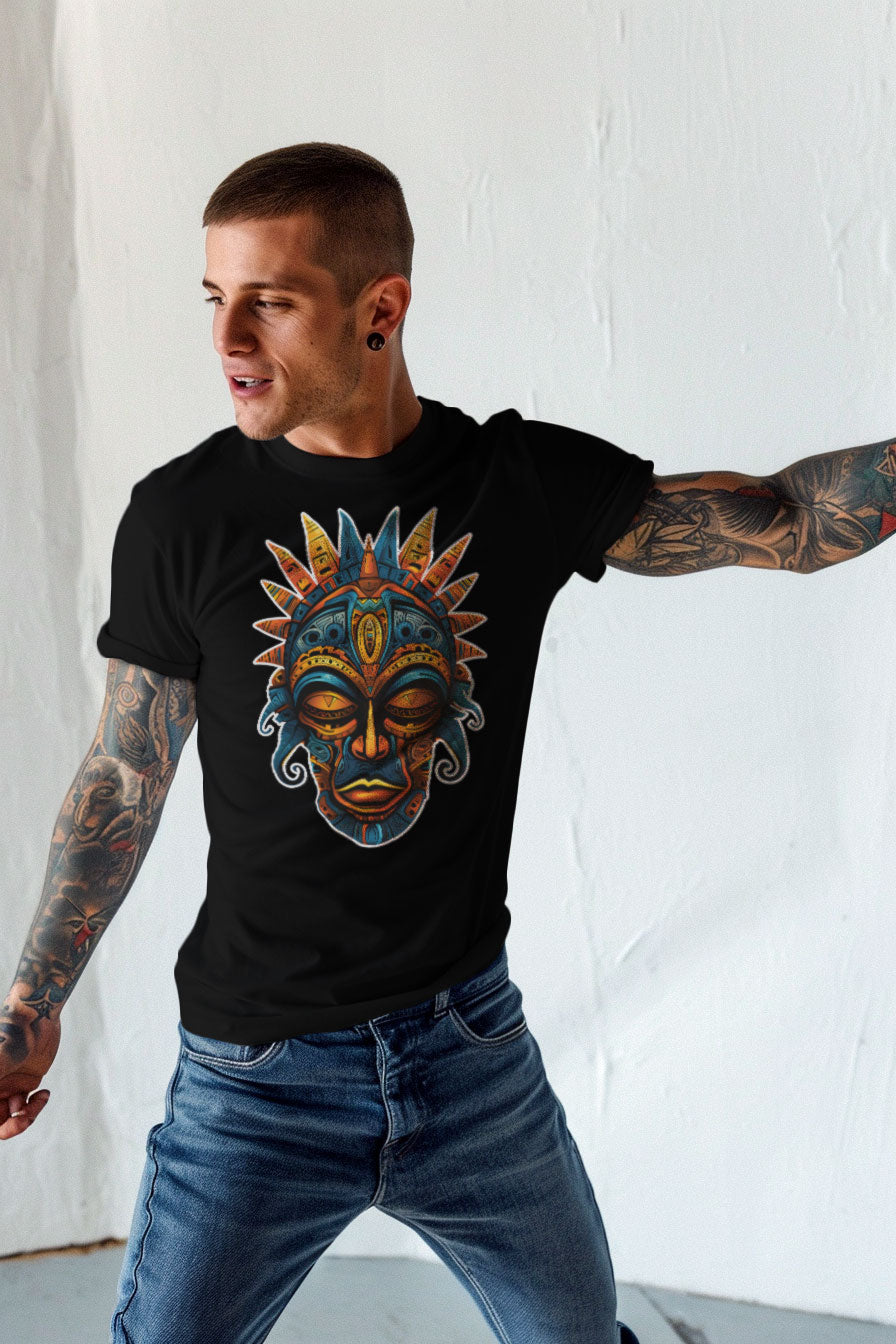 young tattooed man wearing a black graphic t-shirt featuring a Aztec mask print