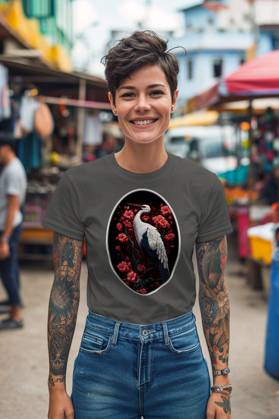 young tattooed woman wearing a gray graphic t-shirt featuring a Crane with cherry blossom trees print
