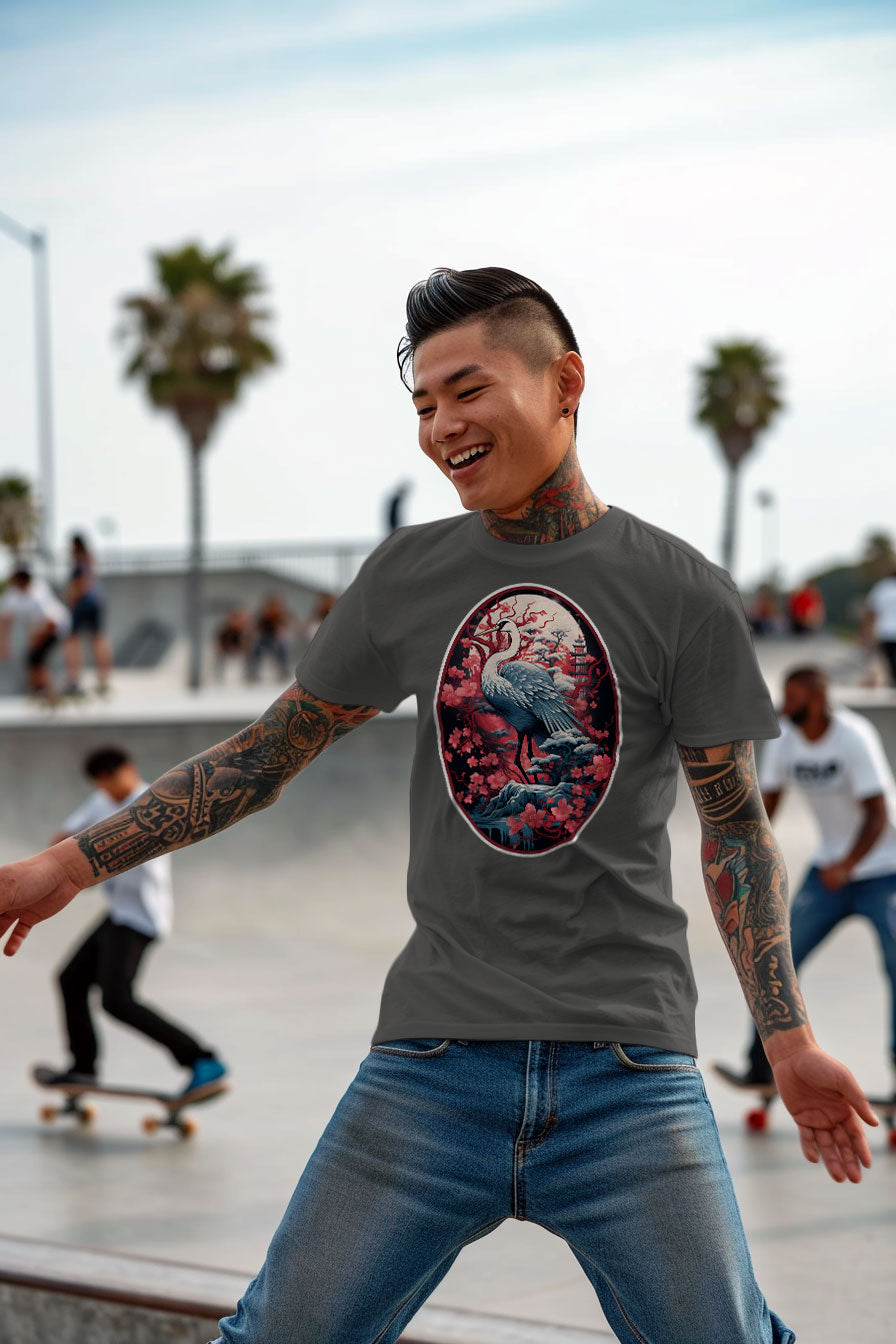young tattooed man wearing a gray graphic t-shirt featuring a Crane with cherry blossom trees print