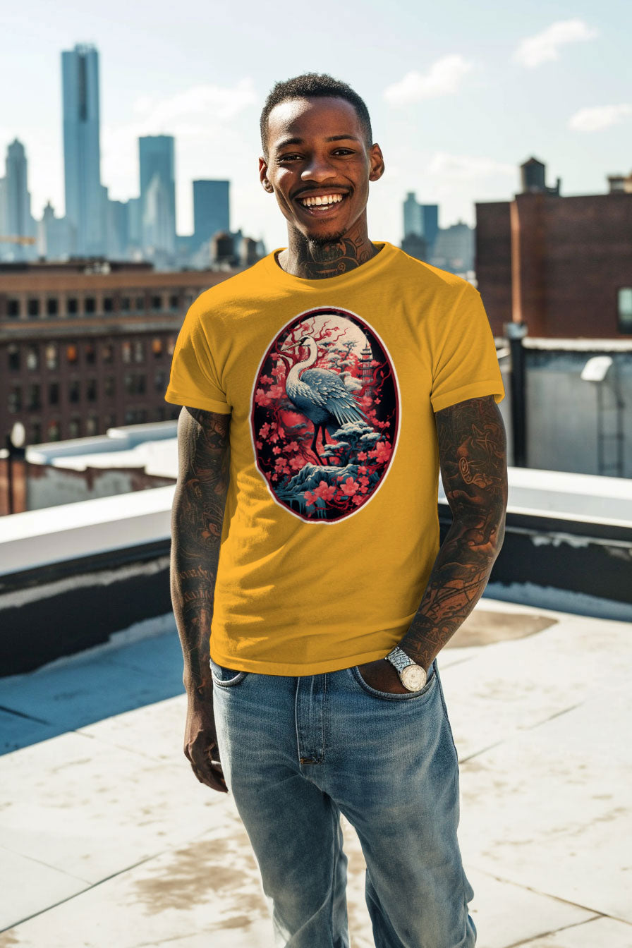 young tattooed man wearing a yellow graphic t-shirt featuring a Crane with cherry blossom trees print