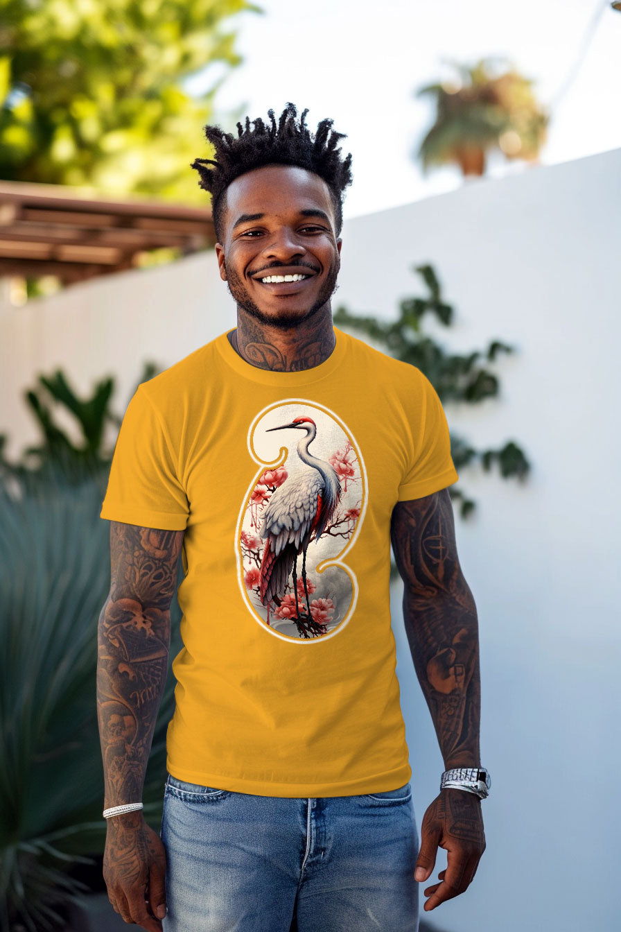 young tattooed man wearing a yellow graphic t-shirt featuring a Crane print