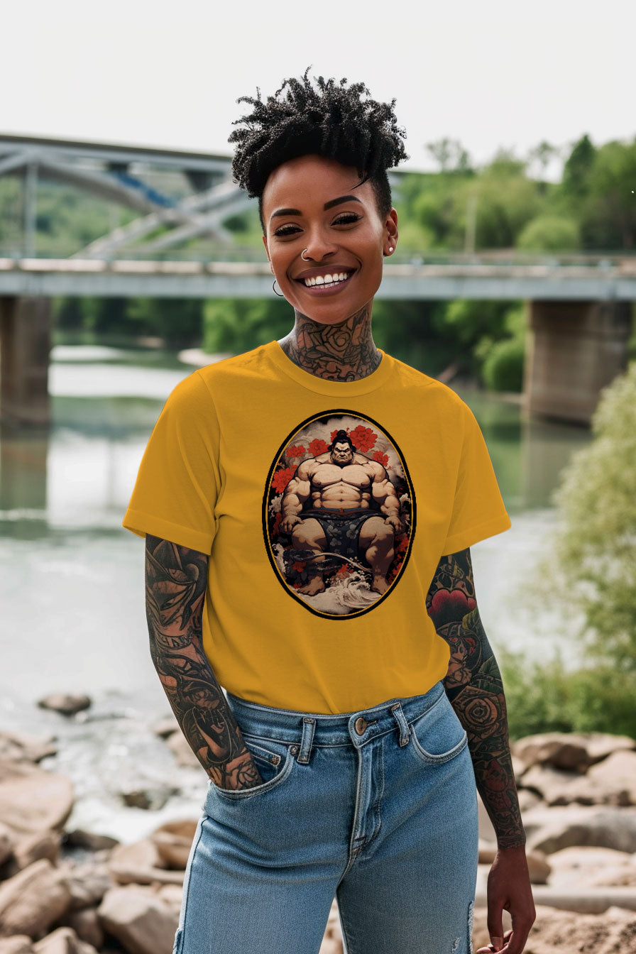 young tattooed woman wearing a yellow graphic t-shirt featuring a Sumo fighter print