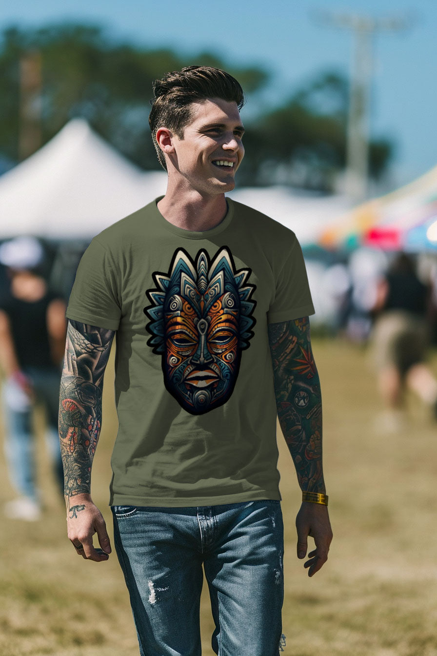 young tattooed man wearing a green graphic t-shirt featuring an African mask print