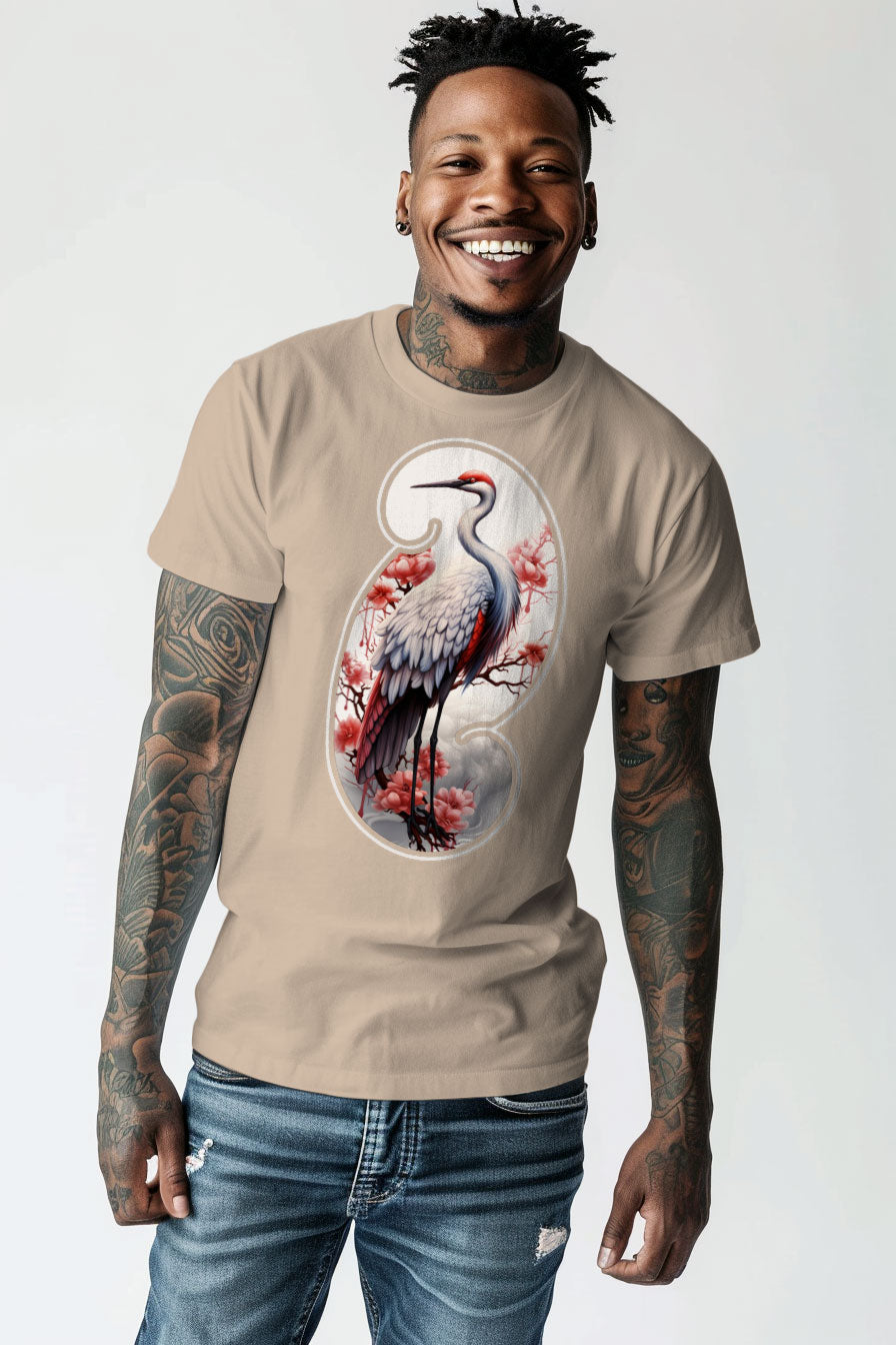 young tattooed man wearing a sand colored graphic t-shirt featuring a Crane print