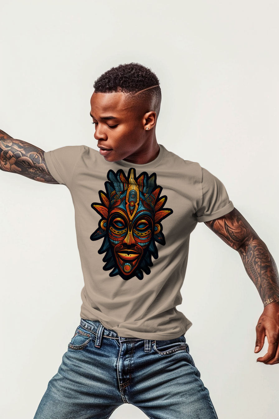 young tattooed man wearing a sand colored graphic t-shirt featuring a Aztec mask print