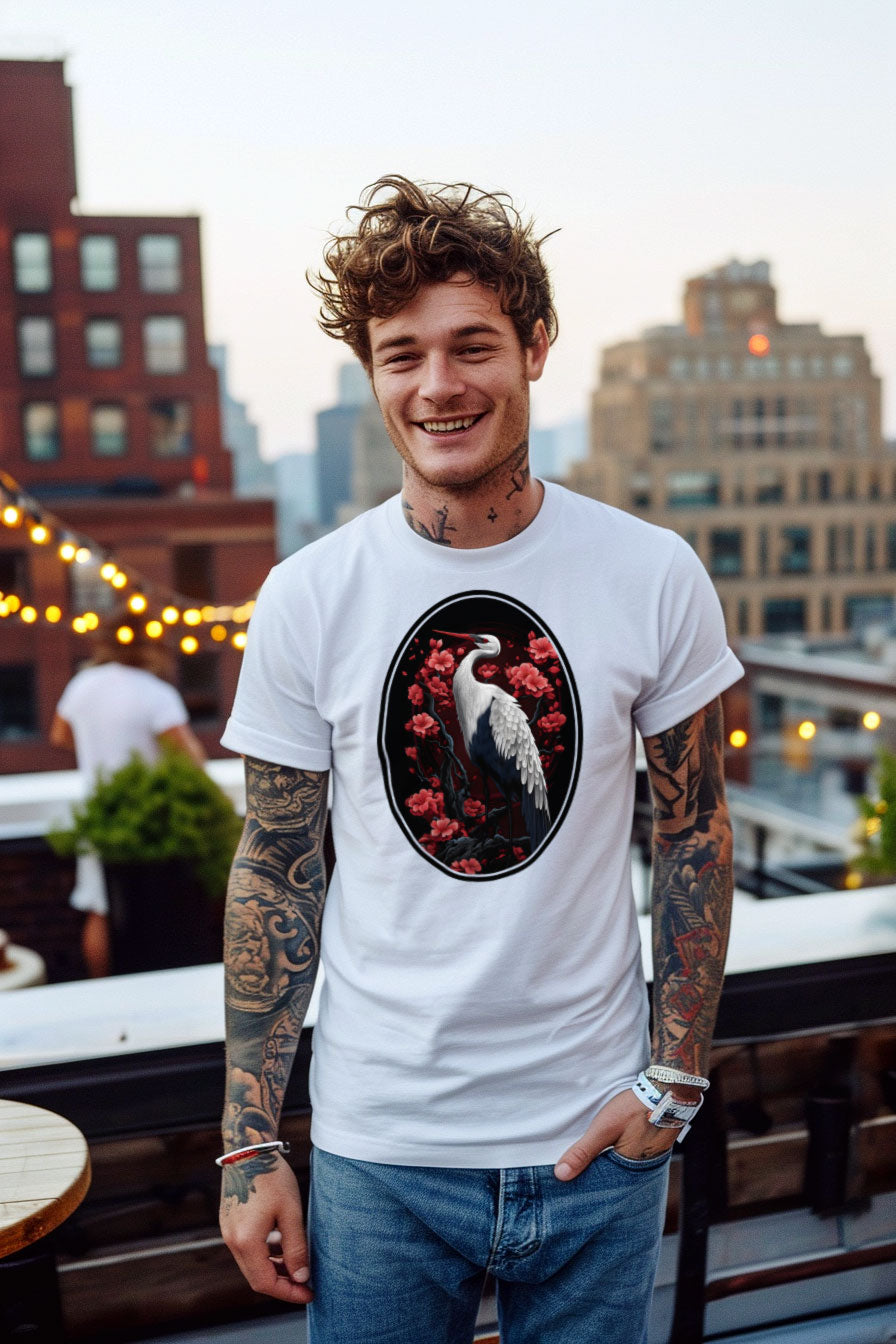young tattooed man wearing a white graphic t-shirt featuring a Crane with cherry blossom trees print